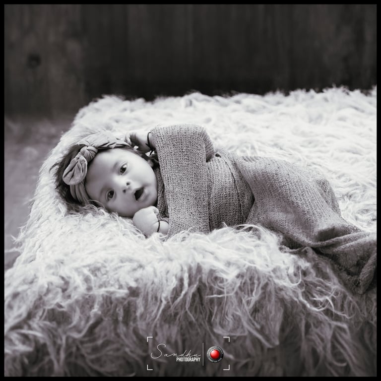 a baby is laying on a blanket in a blanket