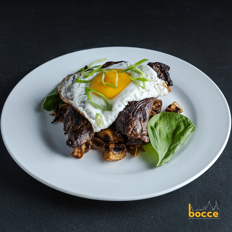flank steak served with mushrooms, fried egg, onion stir fry