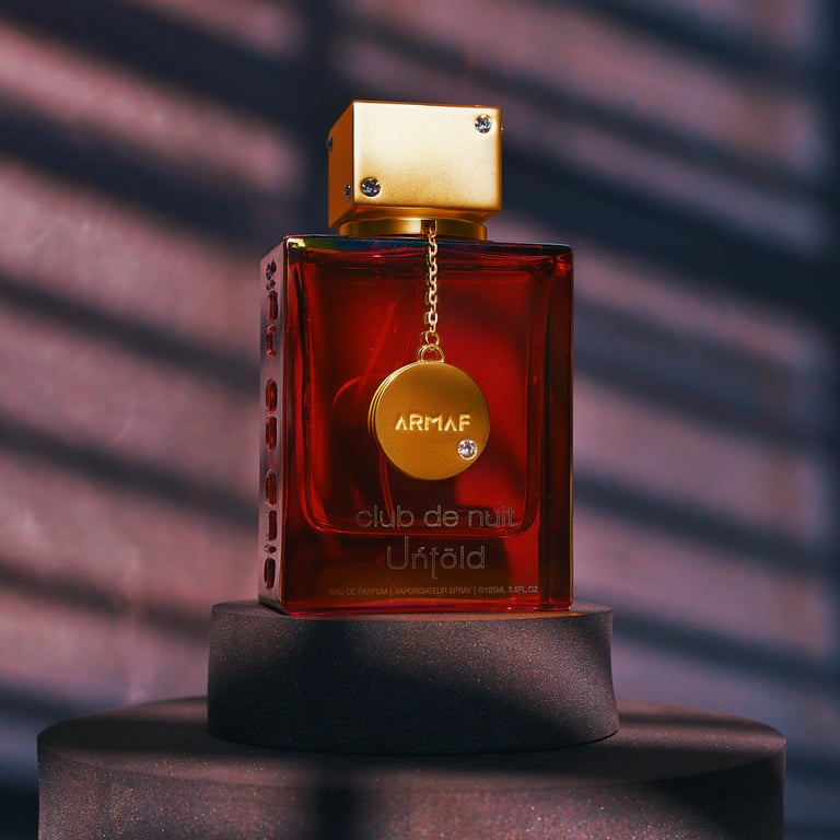 Dark, moody, and cinematic product photo for Armaf Club De Nuit perfume fragrance on dark backdrop with window blind shadow.