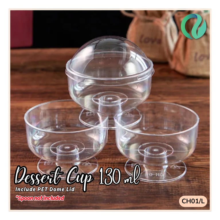 Clear 130ml plastic dessert cup with PET dome lid for parfaits and sweets on a wooden table.