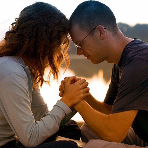 A married couple praying together