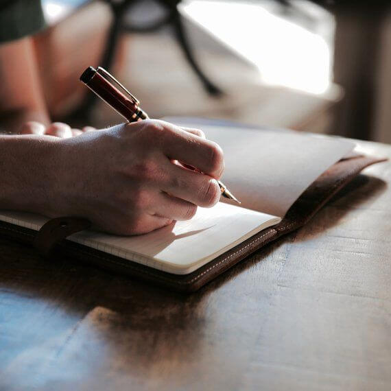 A person setting goals in a planner.