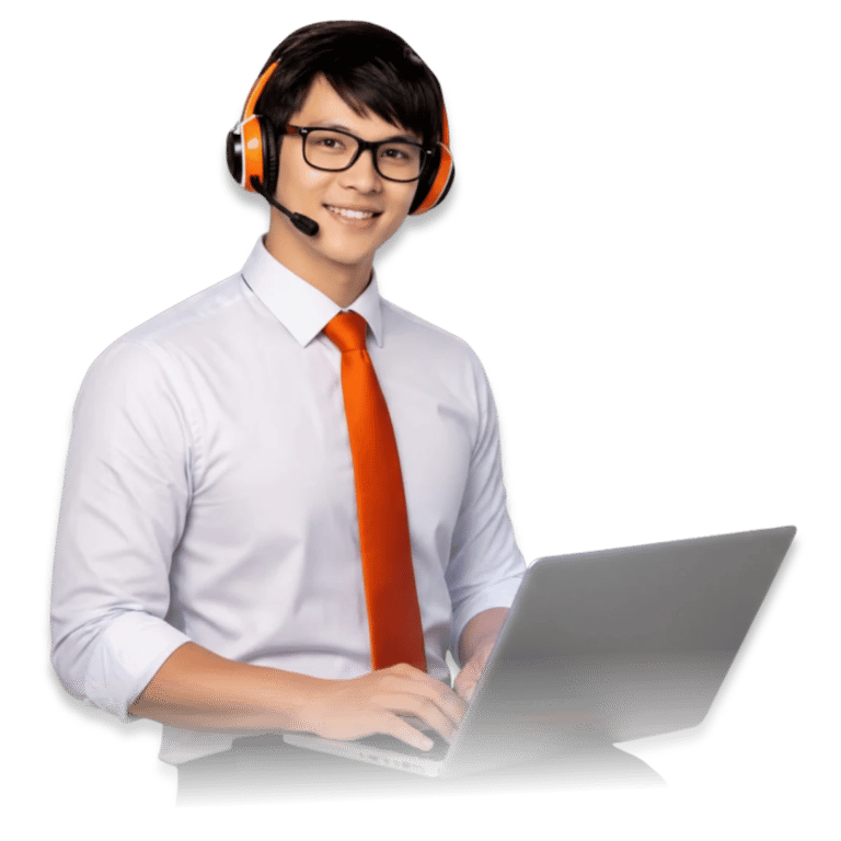 A smiling male taskmanager-nexus tech support agent wearing an orange headset and using a laptop.