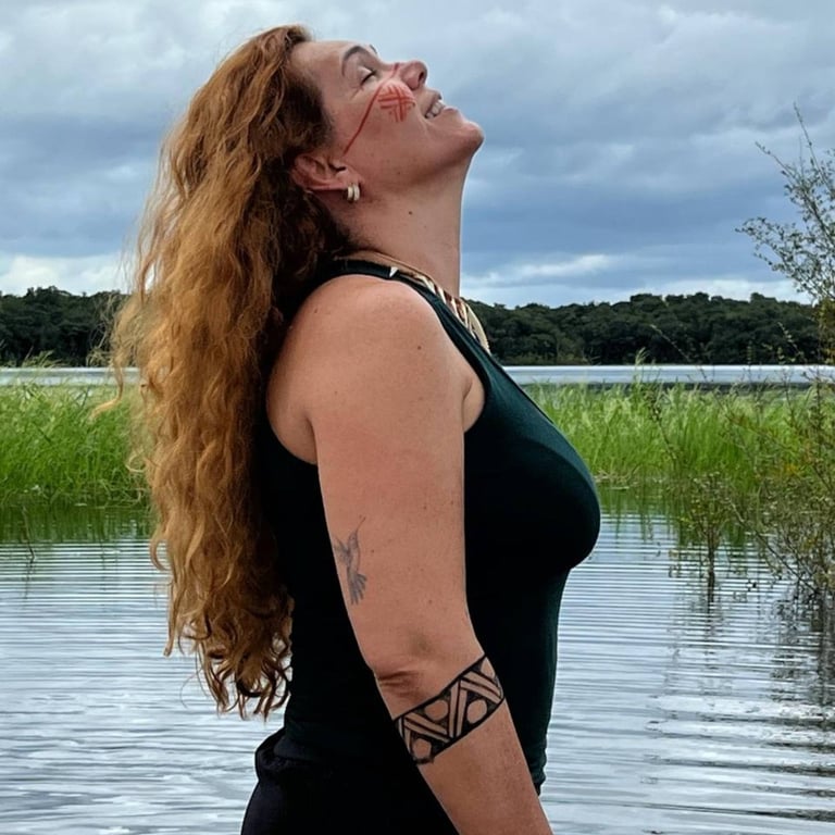 a woman with a tattoo on her arm and a tattoo on her arm