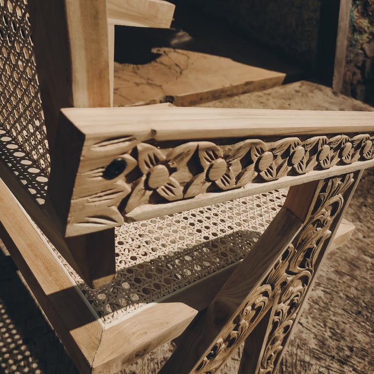 Contemporary chairs made of teak wood and rattan with a combination of distinctive carved ornaments