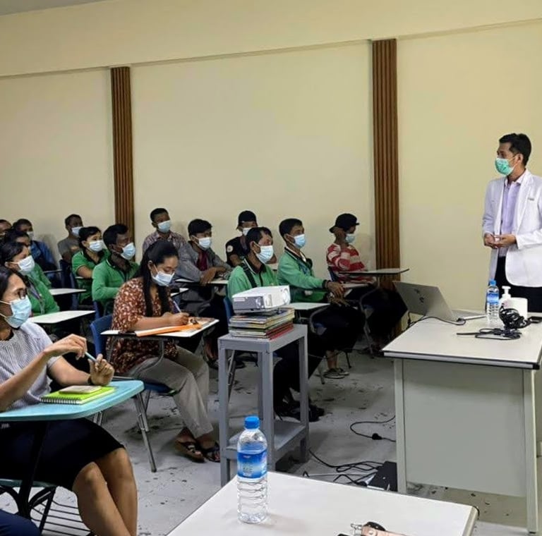 Dr Zaw giving a health talk in a room