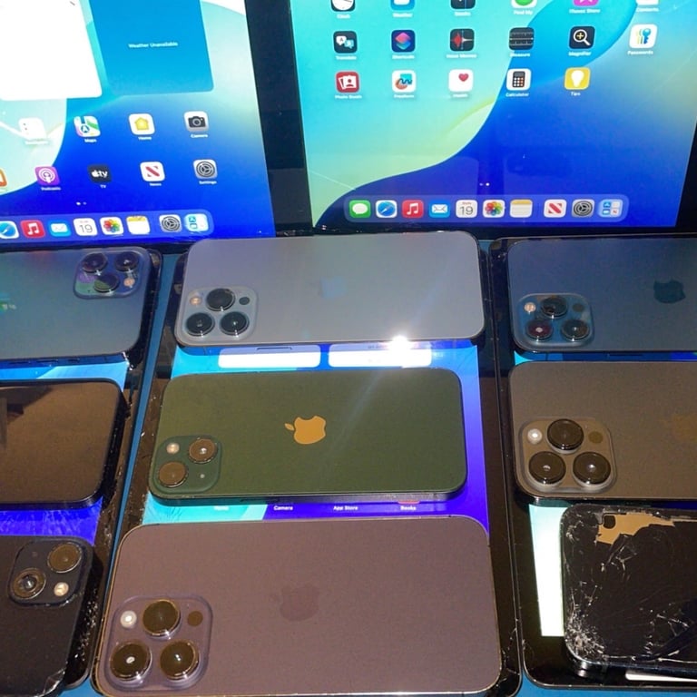 a group of 6 different colored iphones and ipads, broken and working devices 