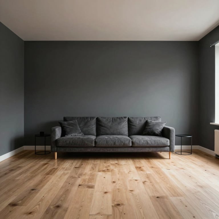 A minimalist living room in a Northern European villa featuring dark grey walls and light oak flooring, captured in soft morning light.