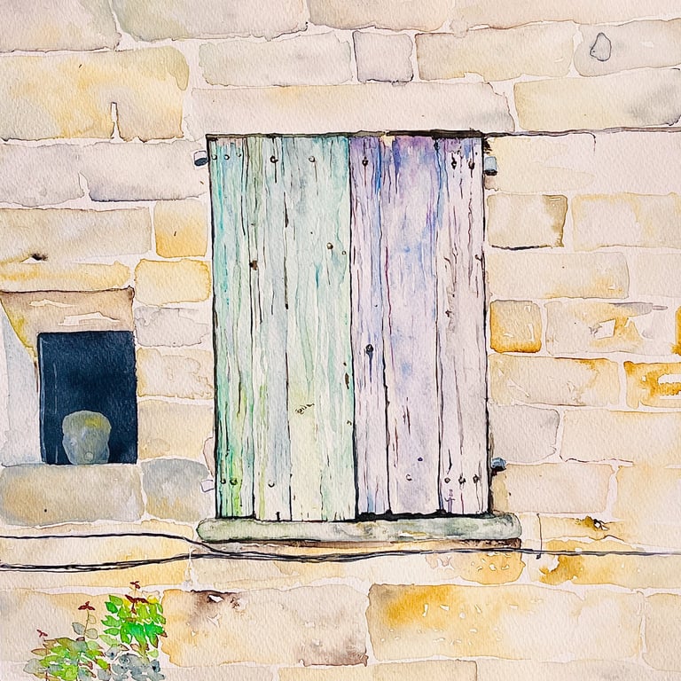 Weathered pale green wooden shutters on beige stone façade