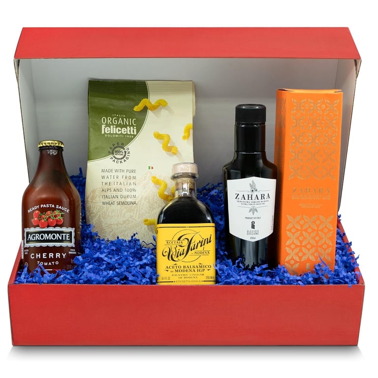 Gourmet Italian food gift basket in a red box featuring organic pasta, tomato sauce, and balsamic vinegar.