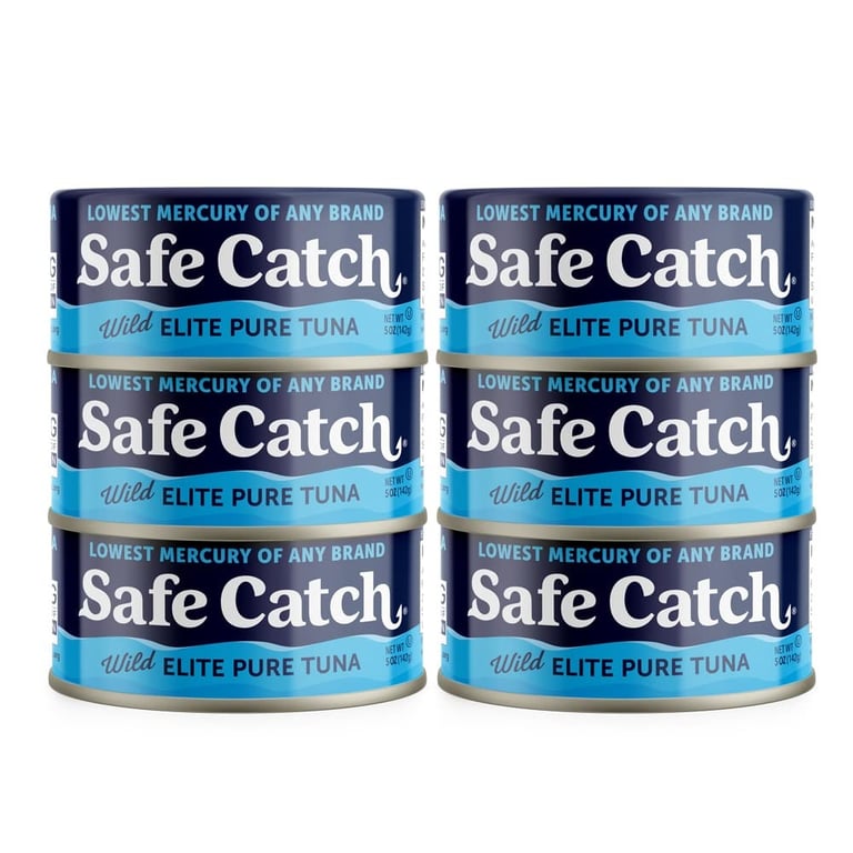 Six cans of Safe Catch Wild Elite Pure Tuna stacked against a white background.