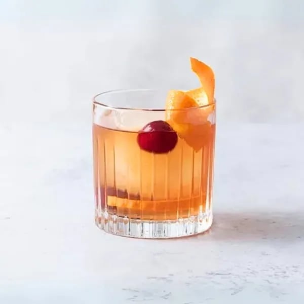 Classic old fashioned cocktail with orange peel and cherry on the event cocktail menu.