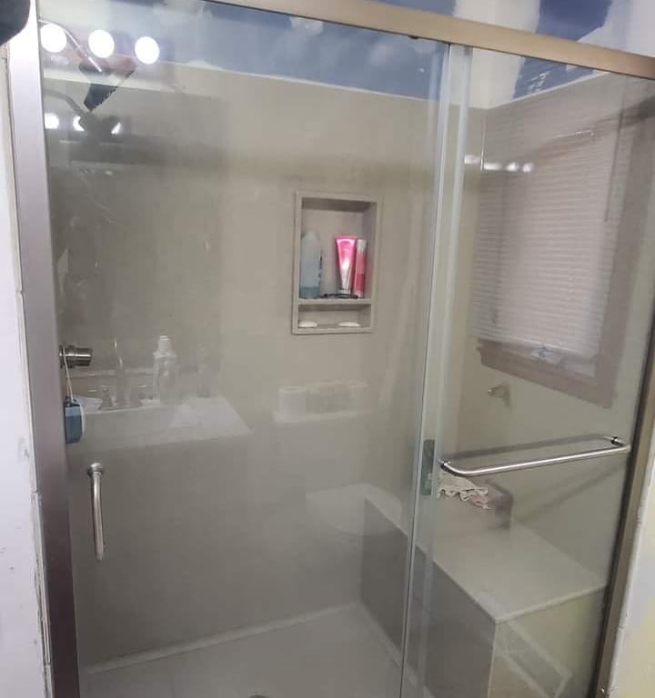 a bathroom with a shower and a shower