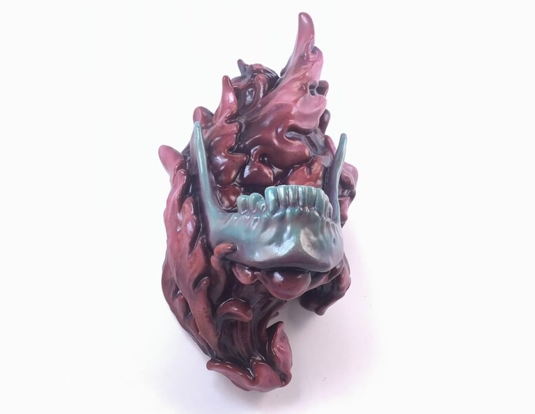 Sculpture of a jaw bone supported by red scrollwork