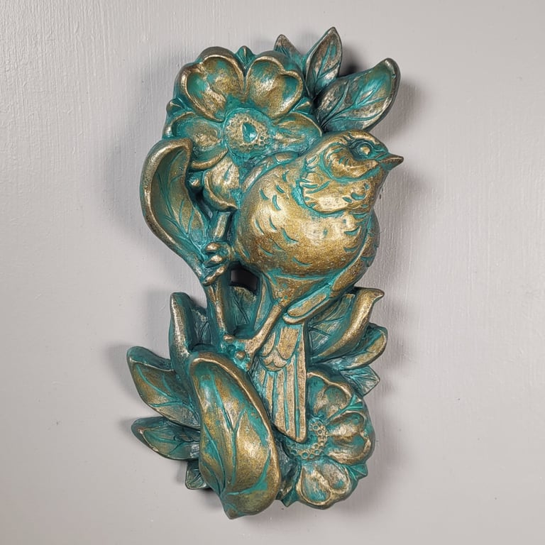 Sculpture of a sparrow perched  on a flower stem. Traditional tattoo inspired art. 