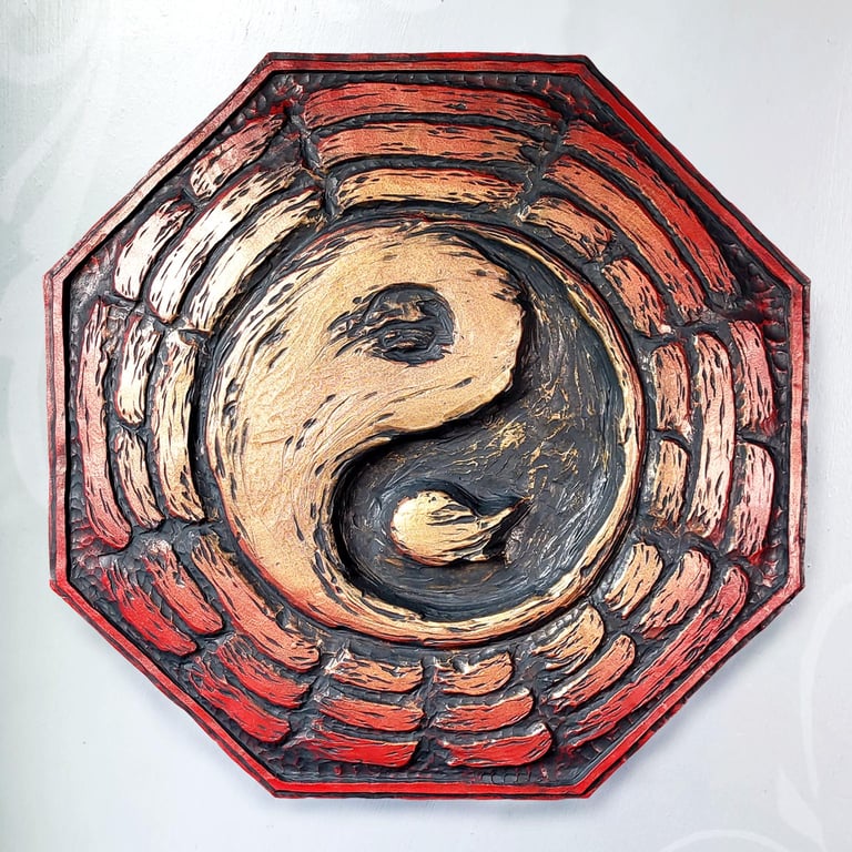 A Bague plaque. The Yin-yang is in the center , surrounded by the trigram.  It is red with gold in the center. 