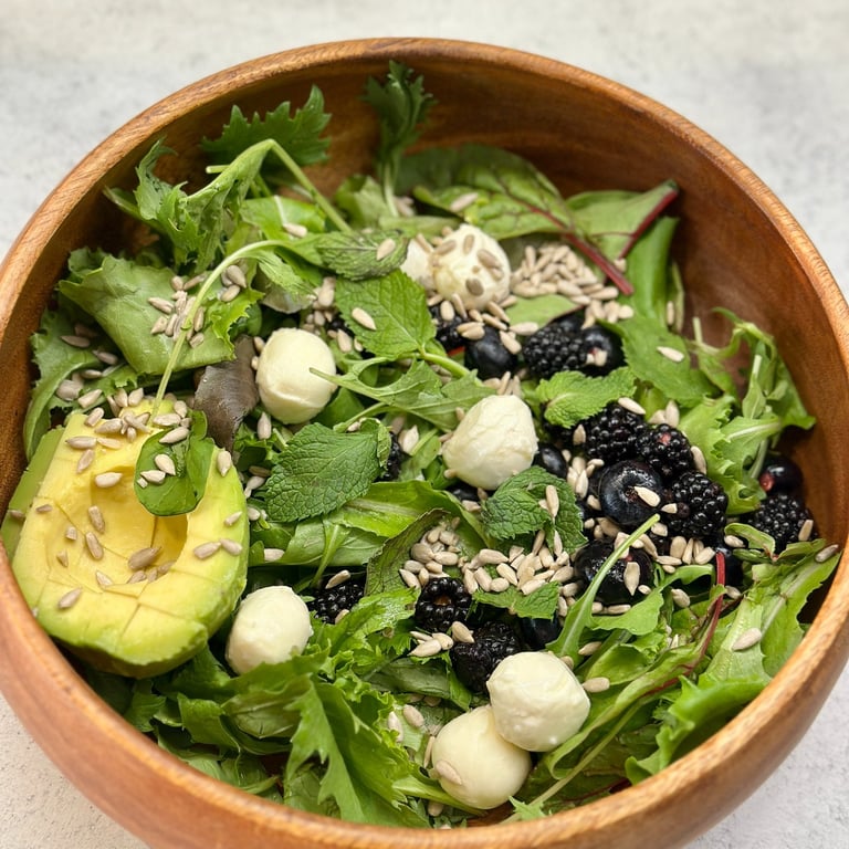 red fruits salad with blueberries, blackberries and avocado