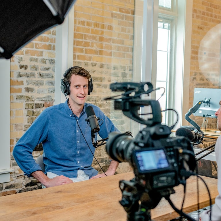 a man in headphones and headphones is recording a video camera - Swrill