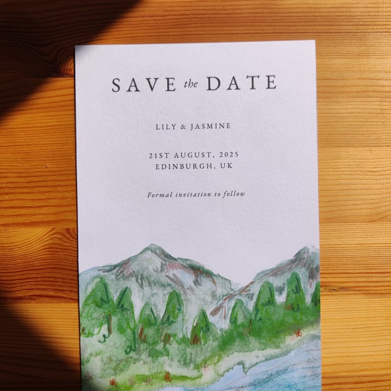 a save the date with an illustration of a mountain
