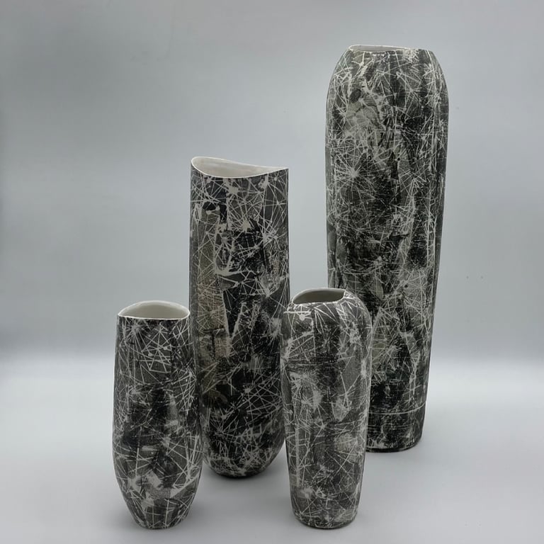 4 tall vases with black and white constellation patterns on the surface