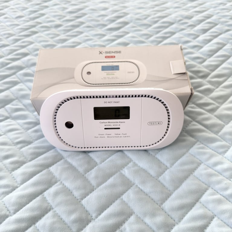 Close up of a portable carbon monoxide detector which can be placed on a table for hotel safety