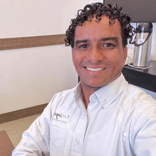 a man in a white shirt and a coffee maker