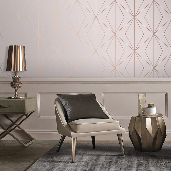 Elegant room with rose gold geometric wallpaper, modern accent chair, and luxury home decor accents.