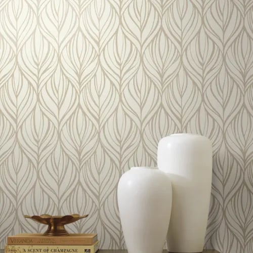 Elegant cream and beige leaf pattern wallpaper behind white ceramic decorative vases on a shelf.