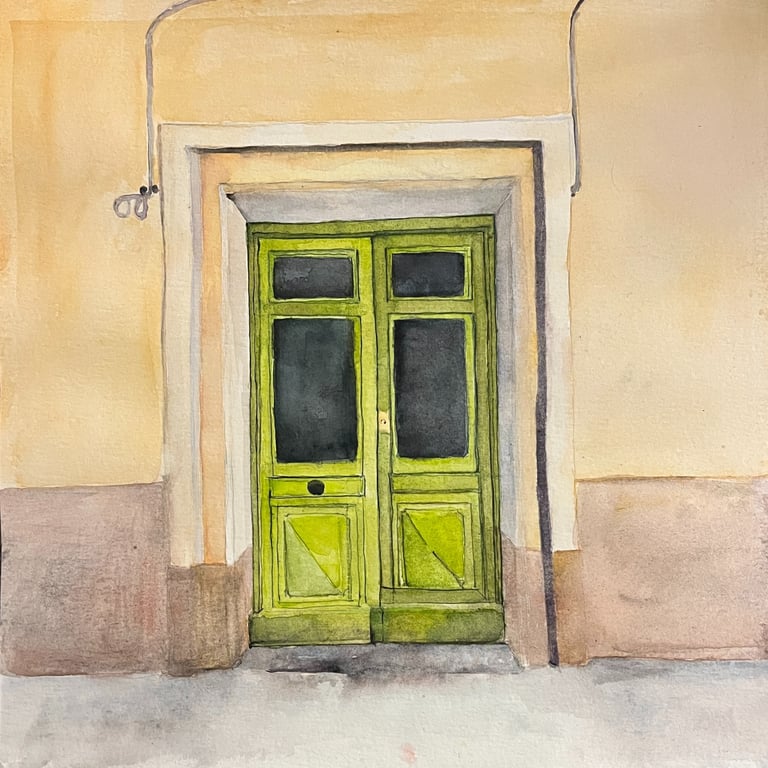 Pistachio green double wooden door set within ochre mineral façade