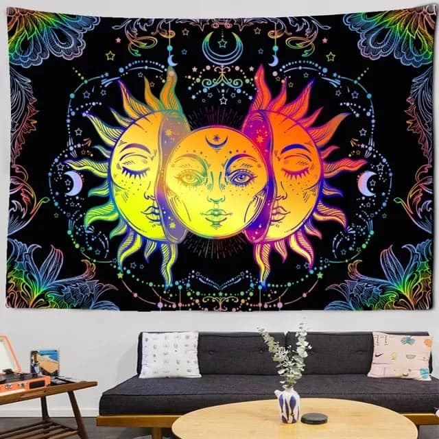 a colorful tapestry tissue with moon and sun hanging  on a wall