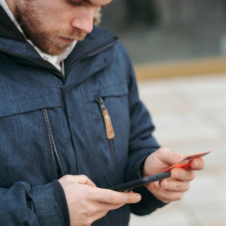 a man in a blue jacket and a black hat