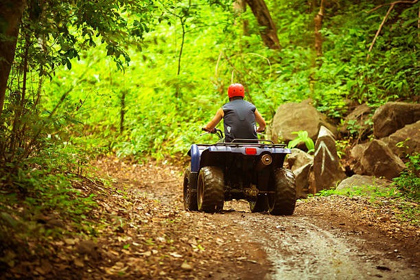 a man riding a four - wheeler atv