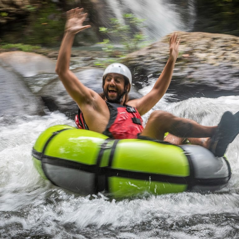 a man is riding a tube in a river