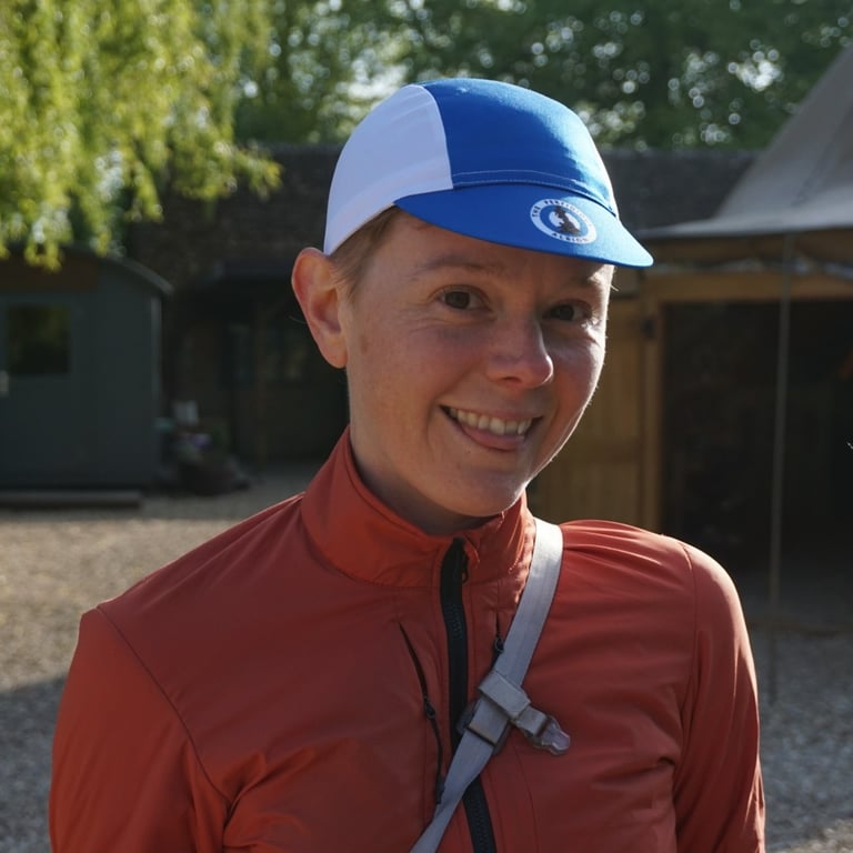 A portrait of Liz Hughes, smiling on a sunny day.