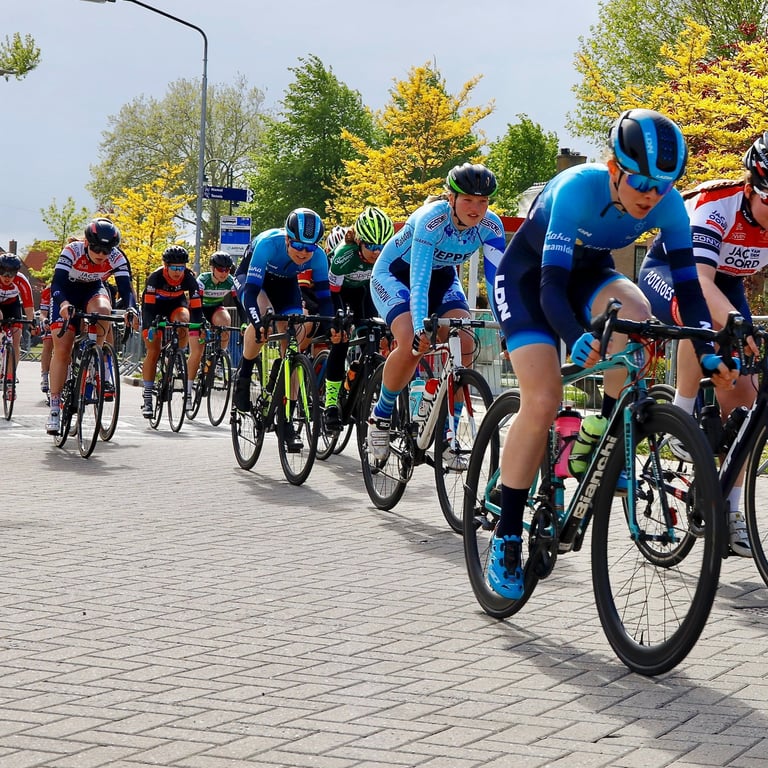 A road bike race with Liz Hughes at the front of the women's peloton