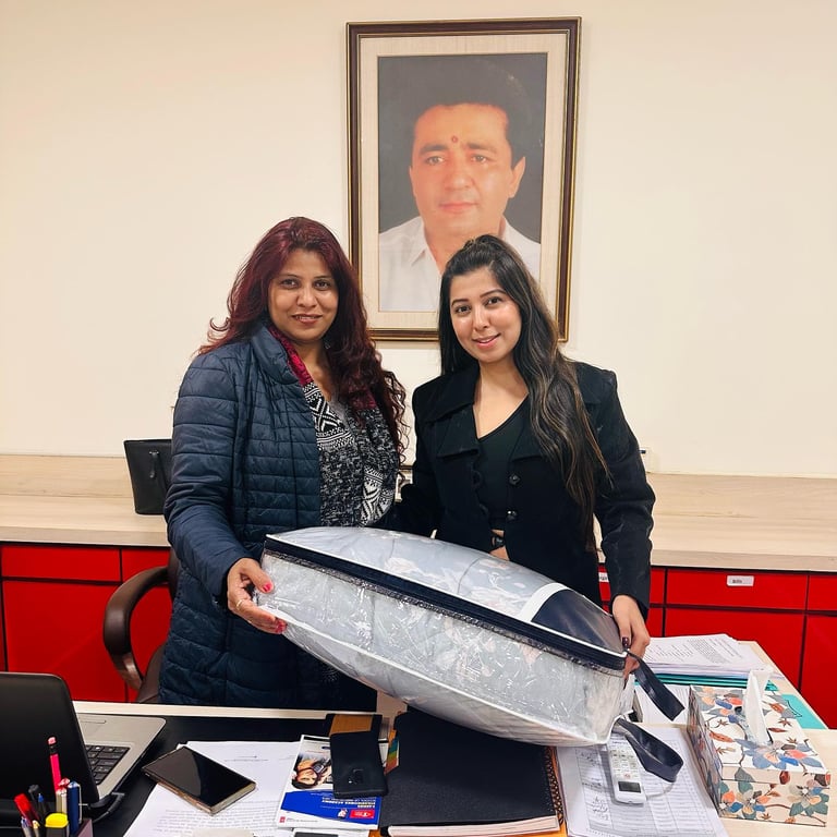 two women standing in front of a desk with a surfboard