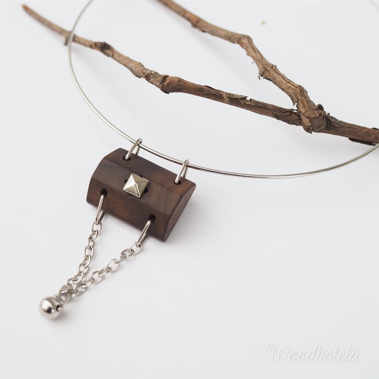 Necklace with wooden pendant decorated with stud and chains