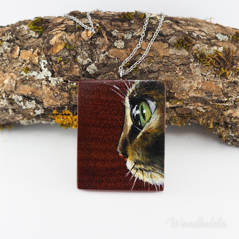 hand painted image of a cat on padouk wood pendant