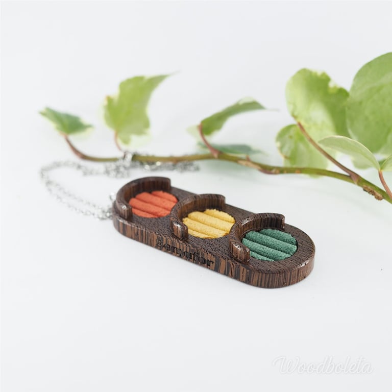 wooden pendant in a shape of traffic light with red, yellow and green corduroy inserts