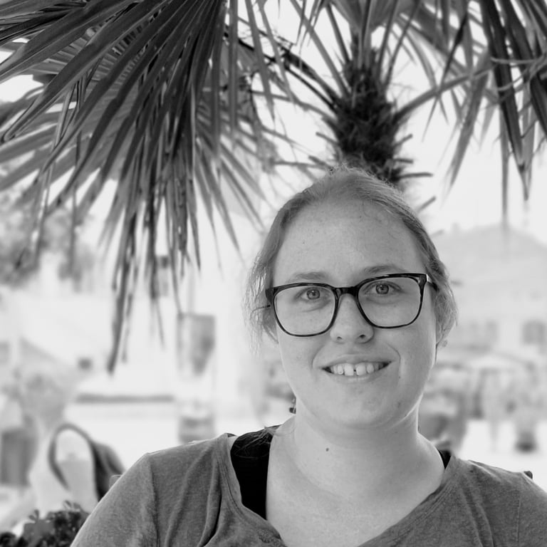 a woman in glasses and a gray shirt