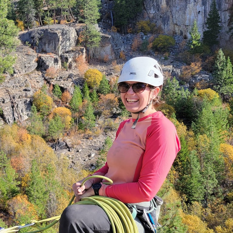 Nat smiling at the top of a climb in Skaha