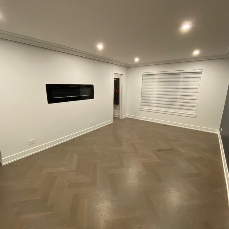 Custom herringbone hardwood flooring installation with modern fireplace in a Chicago North Shore home