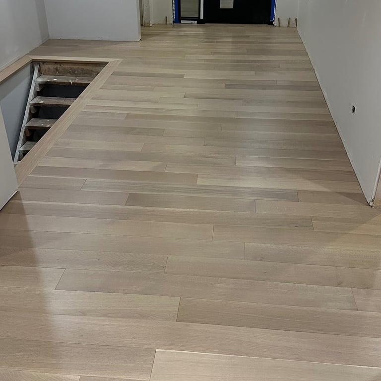 Grand foyer hardwood flooring installation and custom staining in open concept home