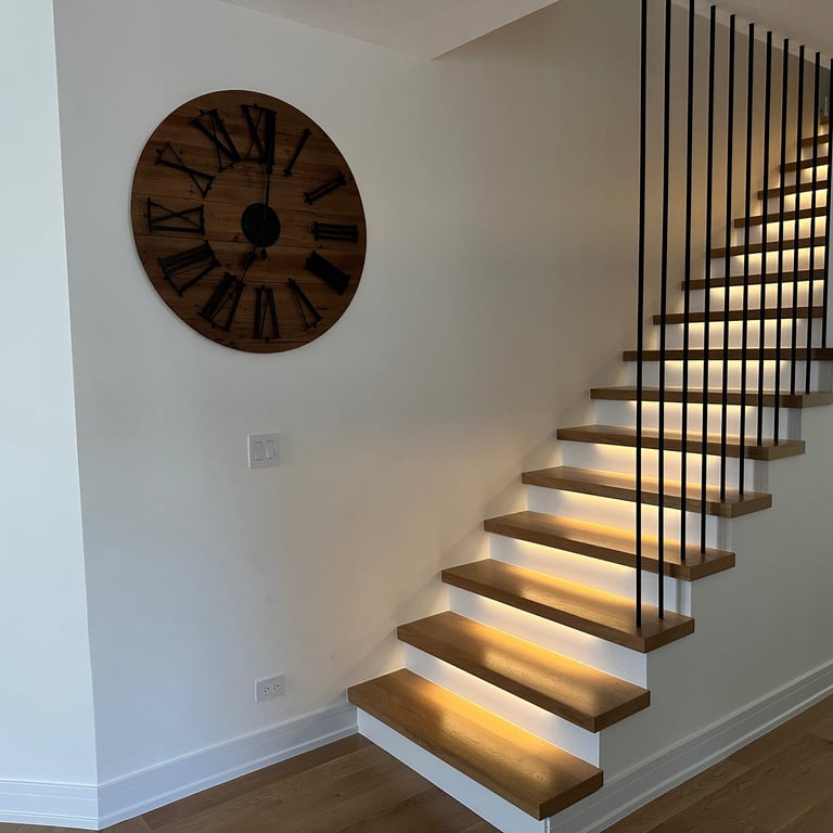 Modern floating oak staircase renovation with LED under-lighting and custom black metal railings