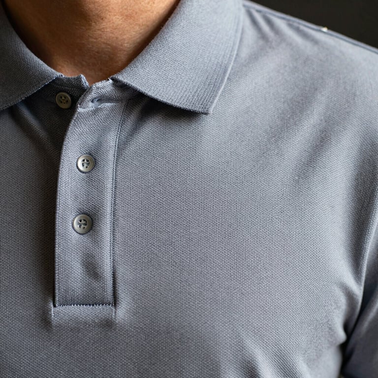 Detailed view of a high-quality embroidery on a polo shirt chest, showing precision and professional stitching.