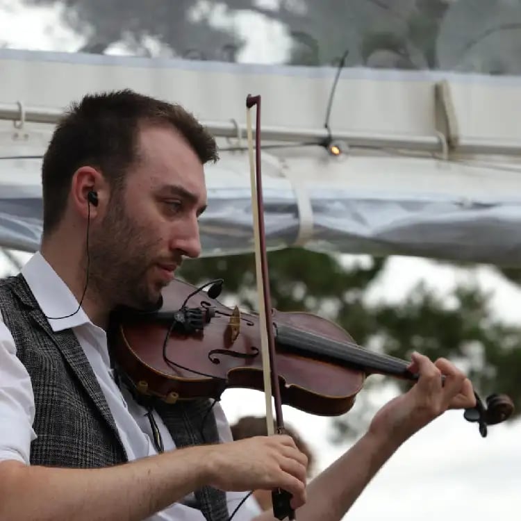 Professional fiddle player performing traditional Irish folk music for a Devon ceilidh band at a wedding