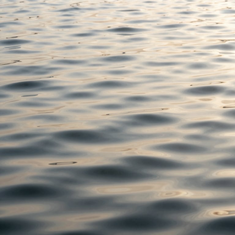 Calm, ripples on a surface of water, lit by soft off-white sunlight, emphasizing the pure and gentle nature of water-based processes.