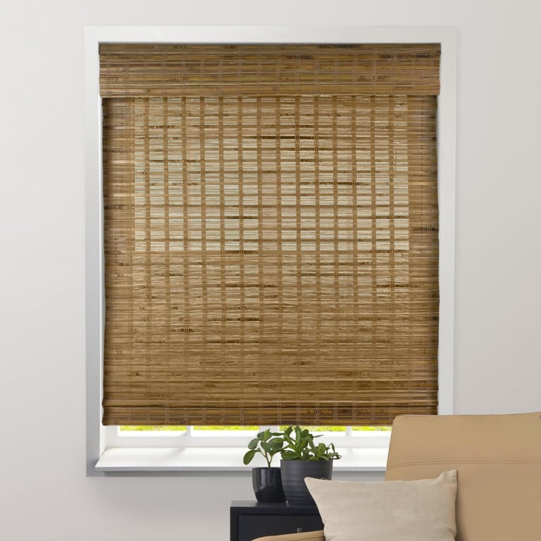 Woven bamboo Roman window shades in a light brown natural wood finish.