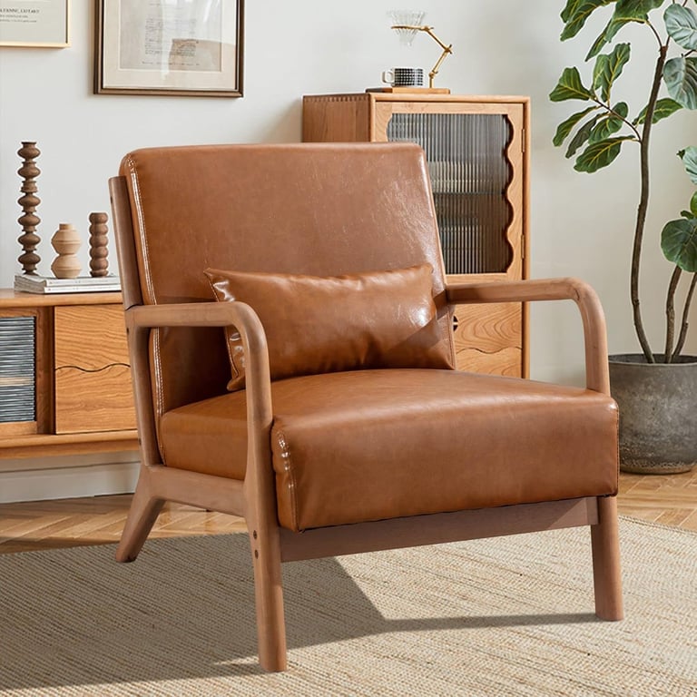 Mid-century modern brown faux leather armchair with a solid wood frame in a stylish living room setting.