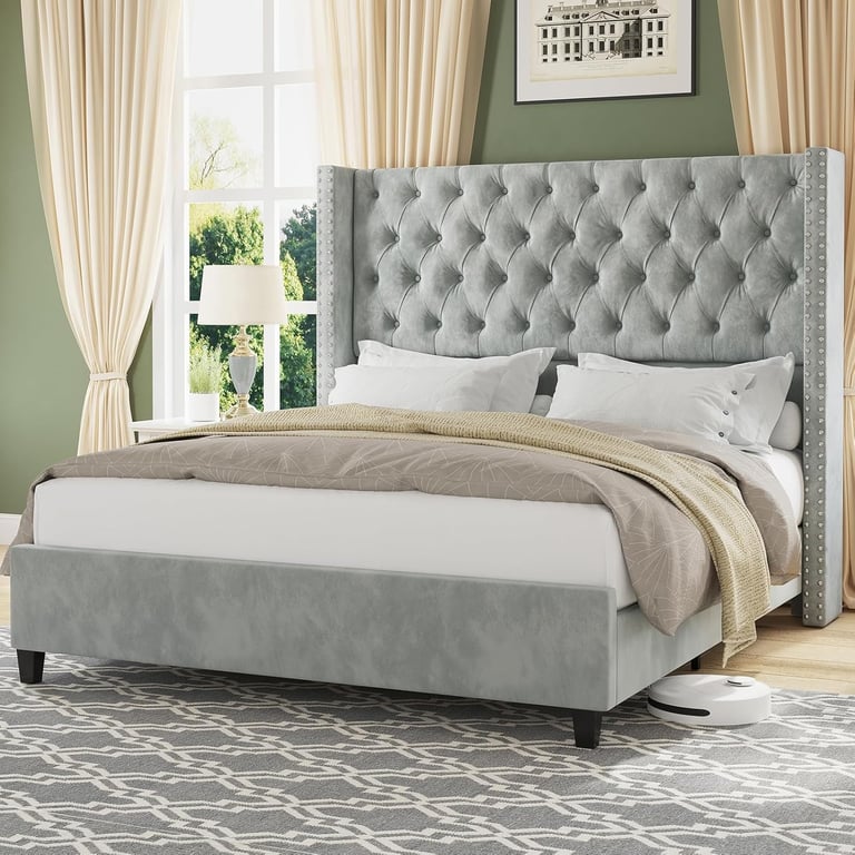 Modern grey tufted wingback bed frame with velvet upholstery in a bright bedroom.